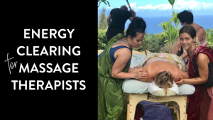 Massage therapists practicing Lomi Lomi outdoors in Maui, performing energy clearing techniques on a client during a Hawaiian healing workshop.